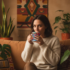 Lifestyle image of African floral ceramic mug with the African Blossoms artwork by Drese Art